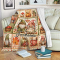 Autumn gnome blanket draped over a sofa with pumpkins, mushrooms, leaves, birdhouses, and cozy rustic artwork