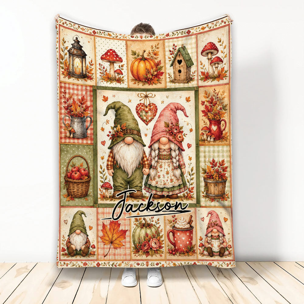 Autumn gnome throw blanket featuring paired garden gnomes, pumpkins, mushrooms, apples, leaves, and rustic cottage motifs