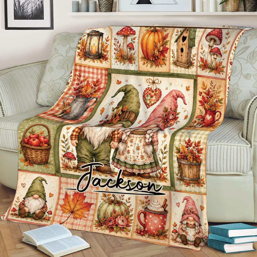Rustic fall gnome throw blanket displayed on a sofa with paired gnomes, pumpkins, mushrooms, and harvest details