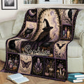 Cozy sofa display of a witchcraft throw blanket with a central witch illustration and gothic magical motifs