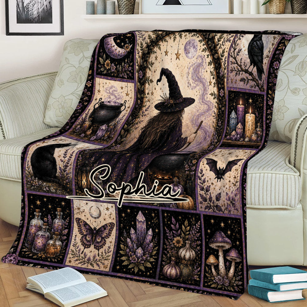 Cozy sofa display of a witchcraft throw blanket with a central witch illustration and gothic magical motifs