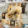 Bee blanket displayed on a couch with honeycomb, sunflowers, daisies, honey dipper, and botanical artwork