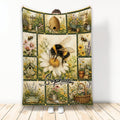 Bee blanket with a large bumblebee, beehive, wildflowers, garden tools, and birdhouses in a vintage garden collage