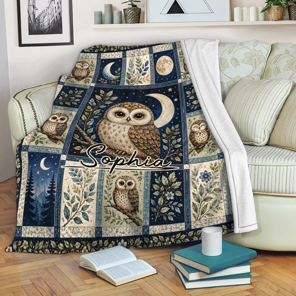 Owl throw blanket draped over a sofa with moon, stars, leafy branches, and woodland-inspired artwork