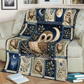 Cozy sofa styled with an owl blanket featuring a central owl, crescent moon, stars, and botanical panels