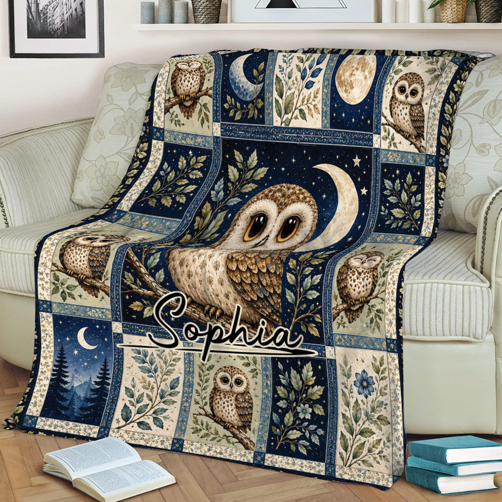 Cozy sofa styled with an owl blanket featuring a central owl, crescent moon, stars, and botanical panels