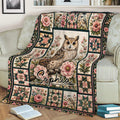 Owl blanket draped across a sofa, featuring floral panels, small birds, and colorful geometric details