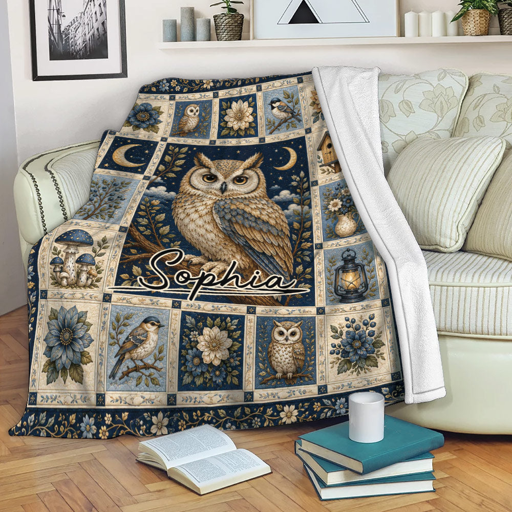 Owl throw blanket displayed on a sofa with ornate floral panels, moonlit artwork, and woodland details