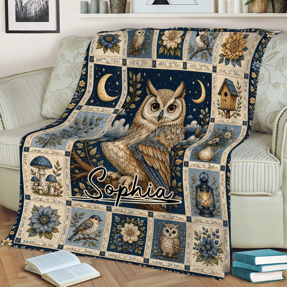 Decorative owl throw blanket draped over a sofa with vintage botanical artwork and deep blue accents