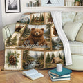 Bear throw blanket draped over a sofa with mountain, cabin, pine forest and woodland artwork
