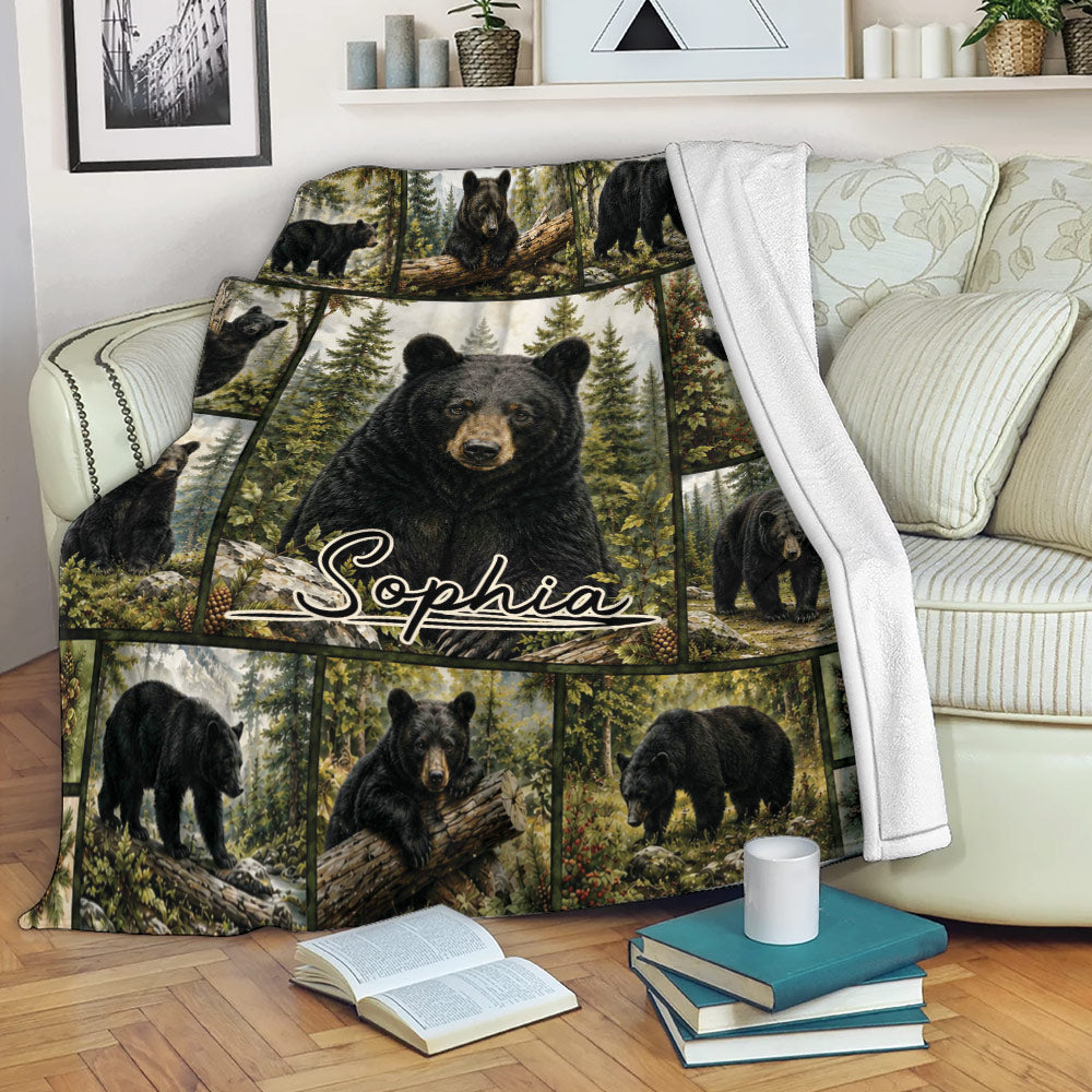Bear blanket draped over a sofa, showing black bears in a detailed evergreen forest scene