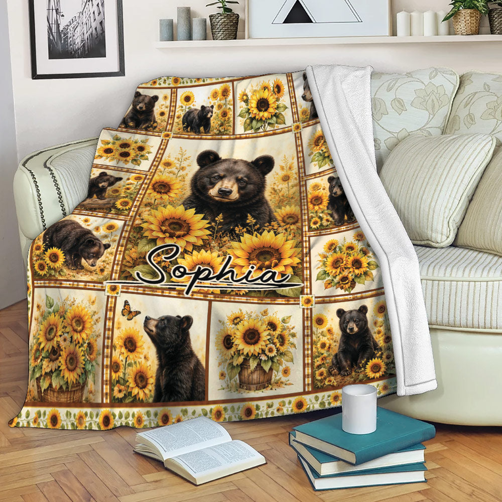 Bear and sunflower throw blanket displayed on a living room sofa with books nearby