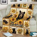 Sunflower bear throw blanket draped across a sofa in a cozy reading room