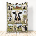 Cow throw blanket featuring Holstein cows, a red barn, daisies, milk cans, and rustic farm scenes