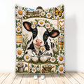 Black and white cow calf blanket surrounded by daisies, butterflies, garden accents, and rustic floral panels