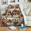 Christmas cow throw blanket displayed on a sofa with snowy farm artwork, festive wreaths, and barn scenes