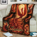 Ornate phoenix throw blanket displayed on a sofa with vivid fiery feathers and dark decorative borders