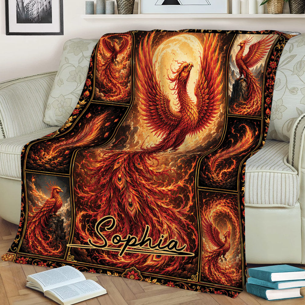 Ornate phoenix throw blanket displayed on a sofa with vivid fiery feathers and dark decorative borders