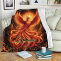 Fiery phoenix blanket draped over a sofa, showcasing radiant red and gold wings and ornate artwork