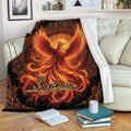 Fiery phoenix throw blanket draped over a sofa with vivid orange and red mythical bird artwork