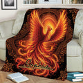 Phoenix throw blanket spread across a sofa, featuring radiant wings and ornate celestial detailing