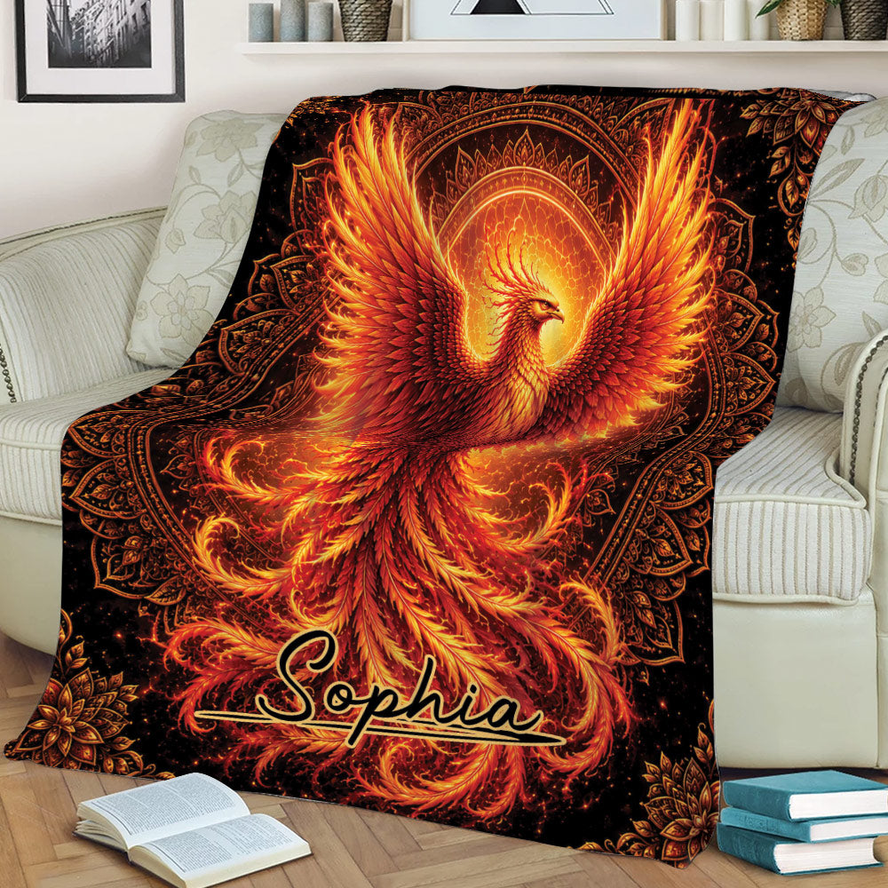 Phoenix throw blanket spread across a sofa, featuring radiant wings and ornate celestial detailing