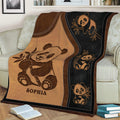 Close view of a panda throw blanket featuring playful pandas, bamboo, and brown black artwork