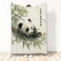 Panda throw blanket featuring a resting panda among bamboo leaves in a standing room display