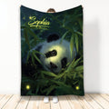 Panda blanket featuring a close-up panda nestled in bamboo with glowing firefly accents