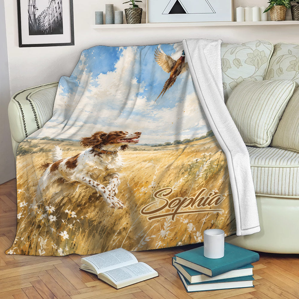 Brittany Spaniel hunting scene blanket draped over a sofa in a cozy living room