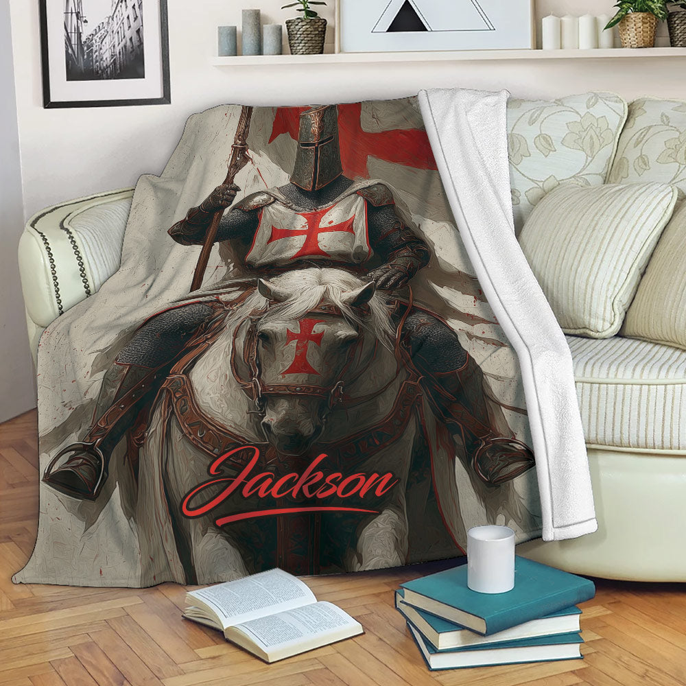 Knights Templar throw blanket displayed on a sofa, featuring an armored knight on horseback in red and black artwork