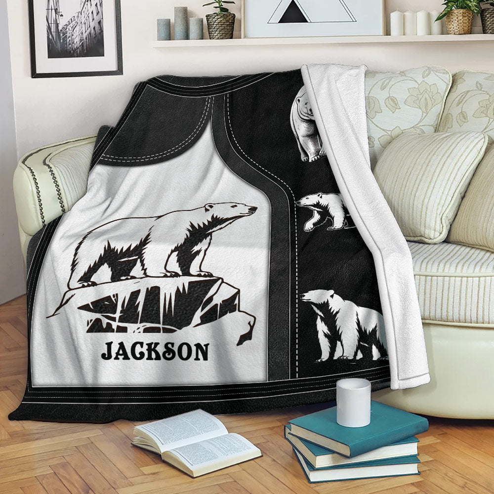 Polar bear throw blanket draped over a sofa, featuring black and white wildlife artwork