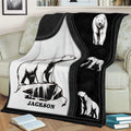Black and white polar bear blanket spread across a sofa with multiple Arctic bear illustrations