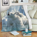 Polar bear and cub throw blanket displayed on a sofa in a cozy living room