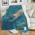 Polar bear throw blanket displayed across a living room sofa with blue aquatic artwork