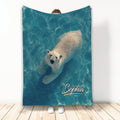 Polar bear swimming through blue water artwork on a custom printed throw blanket