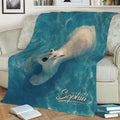 Blue polar bear throw blanket styled on a sofa with an Arctic wildlife design