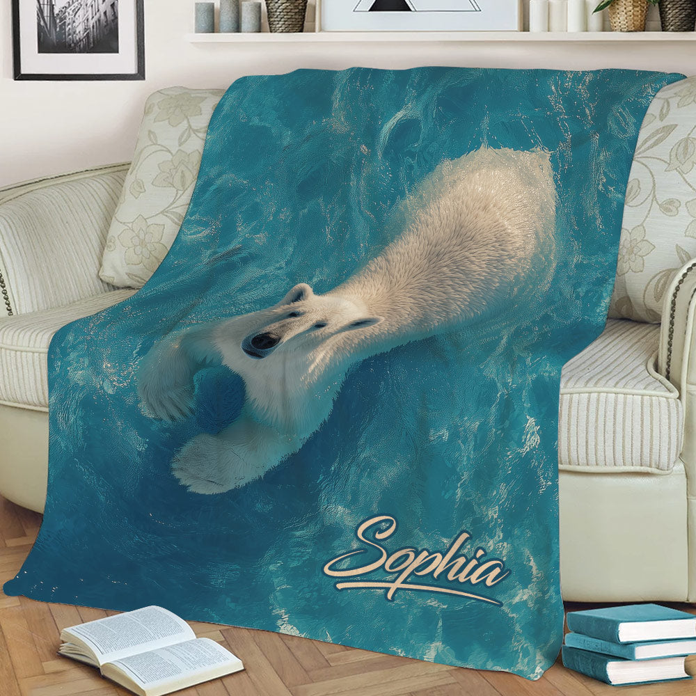 Blue polar bear throw blanket styled on a sofa with an Arctic wildlife design