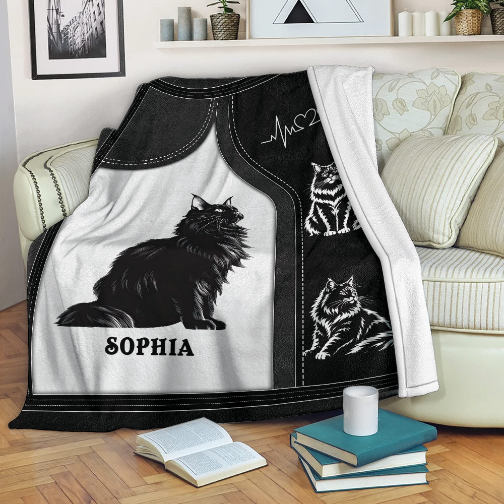 Maine Coon cat throw blanket displayed on a sofa with black and white artwork