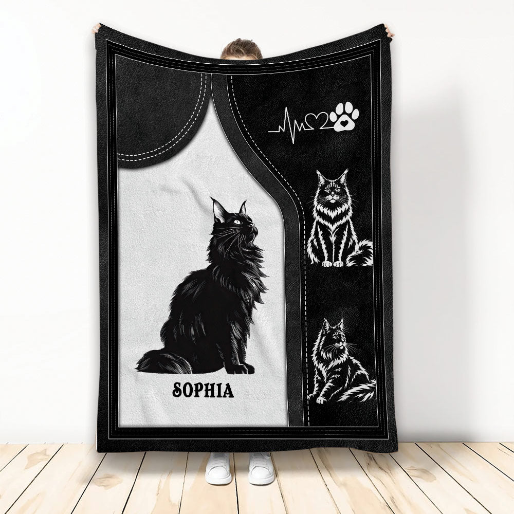 Black and white Maine Coon cat blanket design shown held up in a bright room