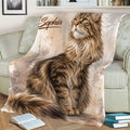 Close view of a Maine Coon cat throw blanket styled across a sofa with watercolor artwork