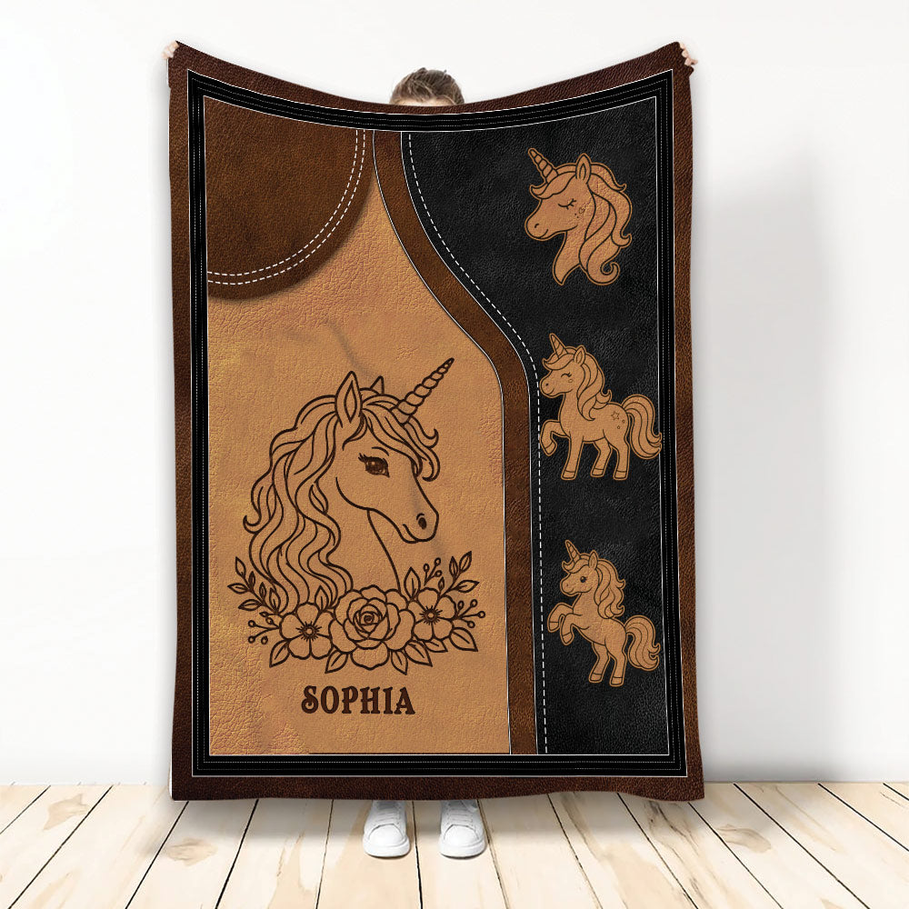 Unicorn blanket displayed upright with floral unicorn artwork and a warm brown, black, and gold design