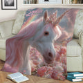 Pastel unicorn throw blanket displayed on a sofa with a jeweled horn, pink mane, butterflies, and floral artwork