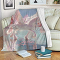 Pastel winged unicorn throw blanket displayed on a cozy sofa