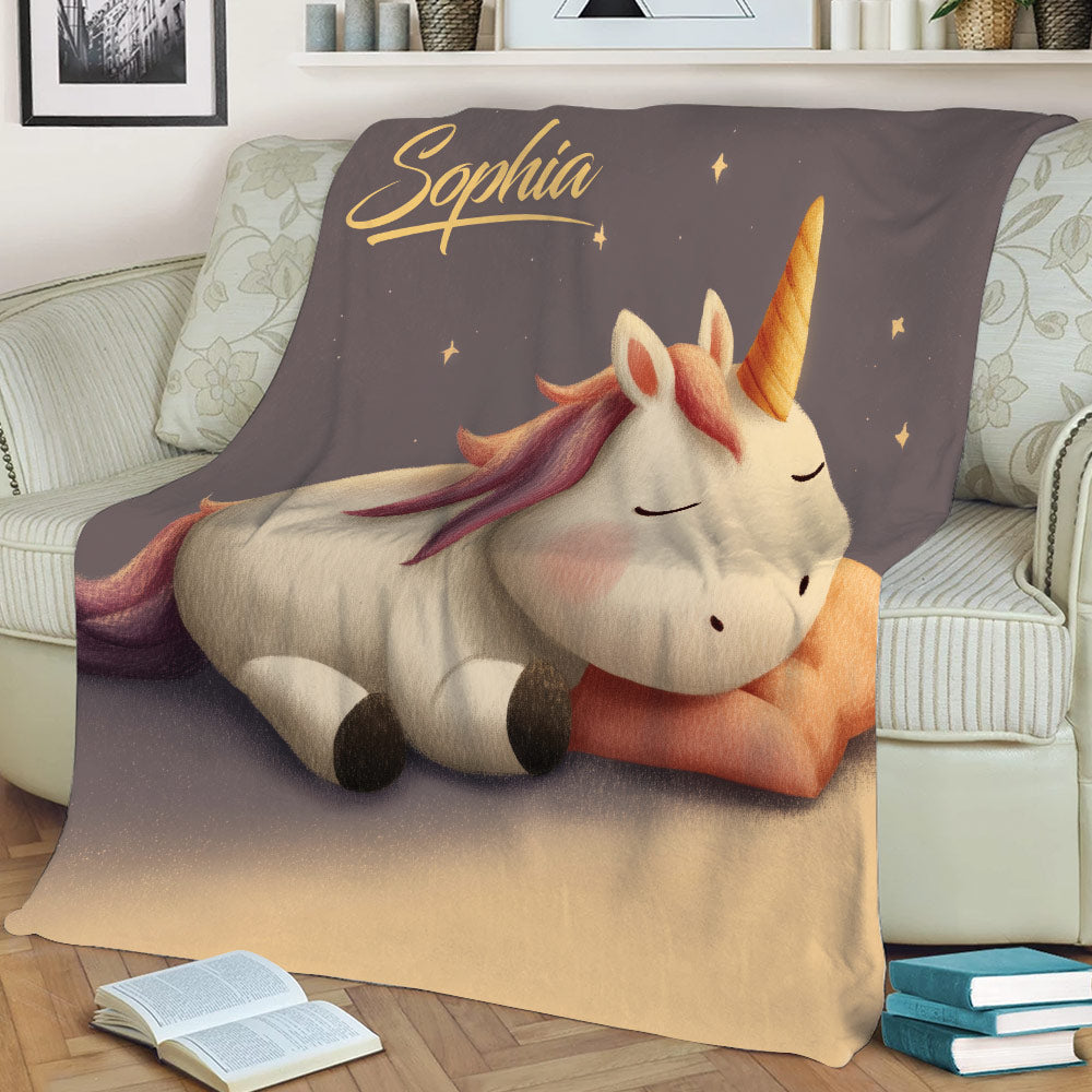 Unicorn blanket styled on a couch, featuring a resting fantasy unicorn with colorful mane and stars