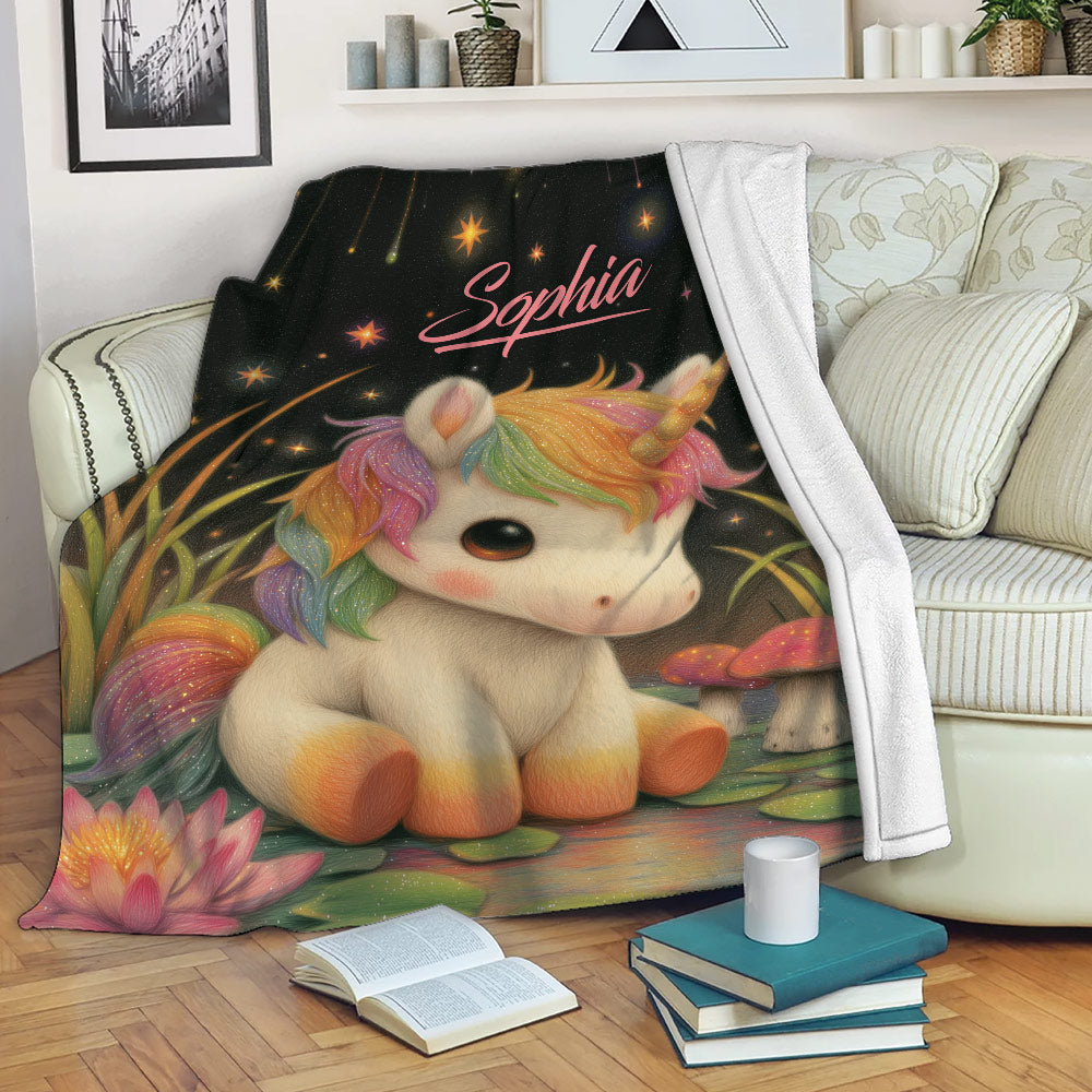 Colorful unicorn throw blanket draped over a living room sofa with stars, flowers, and mushrooms