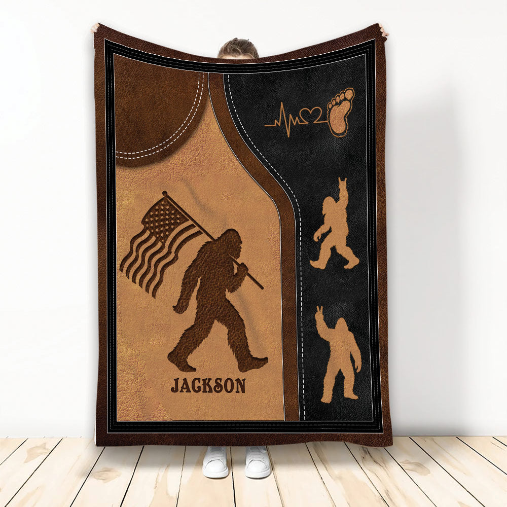 Bigfoot throw blanket with patriotic flag artwork, rustic brown and black design, displayed upright