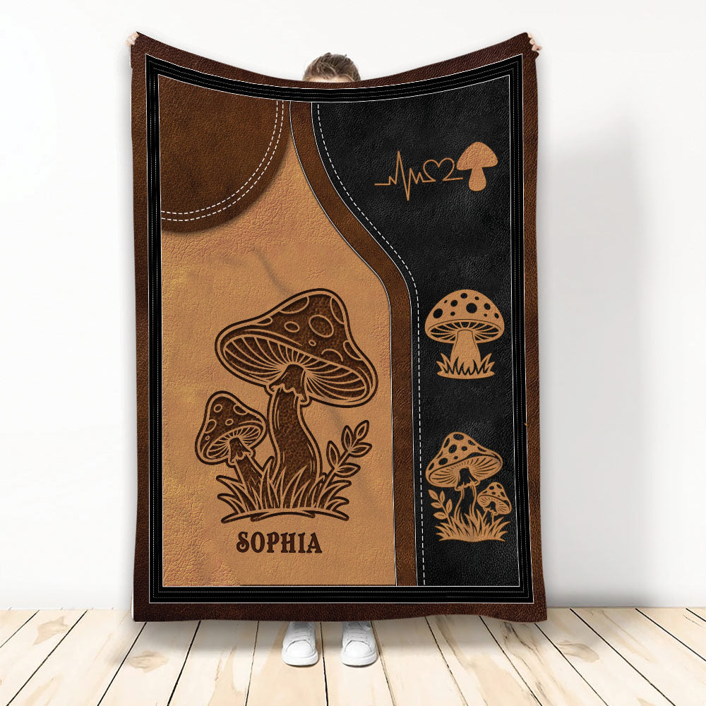 Rustic mushroom throw blanket displayed upright with brown and black woodland artwork