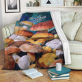 Colorful mushroom blanket draped over a sofa in a cozy reading room