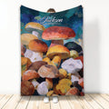 Colorful mushroom throw blanket displayed upright with painterly forest fungi artwork